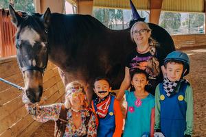 Children horse and staff member