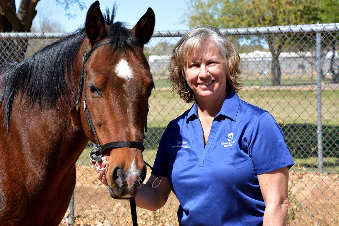 Stefani standing next to a horse